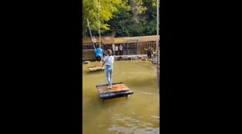 Watch visitors negotiate this awesome obstacle course over pond