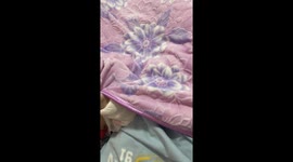 Shy little baby hides under bed covers