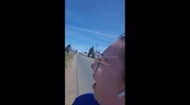 Woman in awe as helicopter flies overhead and lands right next to her