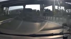Truck cargo topples off while going round bend