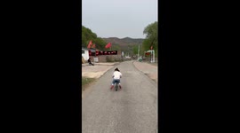 Girl falls off bike while trying stunt down road