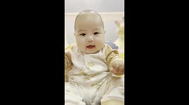 This bald baby has the most adorable laugh