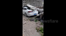 Wall collapse in powerful winds flattens dozens of cars in China