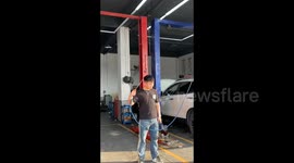 China: Man is using an air gun at the auto repair shop