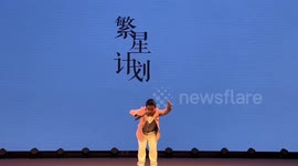 Touching moment dad stands side to side to support disabled son on stage