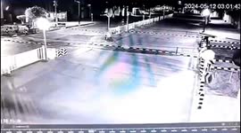 Train hits motorcyclist who crashes through railway barrier and falls on tracks