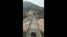 Thrilling bike ride on a suspended Himalayan bridge