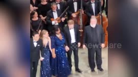 King Charles beams as appears on Royal Opera House stage