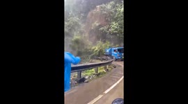 Tanker truck narrowly escapes being buried by landslide in Indonesia