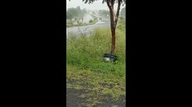 During a heavy rain, an over speeding car looses control and roll several times.