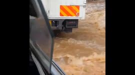 During a heavy downpour, Vehicles swept away by floods as passengers tries to escape.