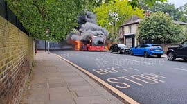 Dramatic moment a bus burst into flames as 30 firefighters try to tackle the blaze