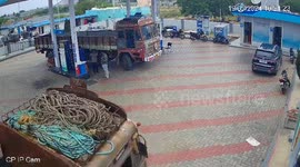 Pump attendant calmly douses flames engulfing lorry at petrol station