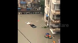 Residents swim to safety as the ground floor submerged in deep flood