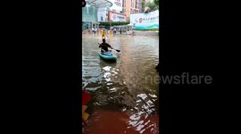 Chinese man uses kayak to shop for rice noodles in heavily flooded streets
