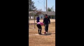 Blindfolded boys play chaotic football at school
