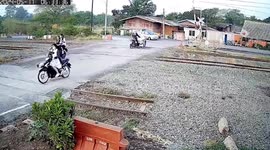 Motorcycle rider gets stuck on level crossing as train approaches