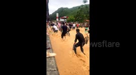 Commuters catch fish on flooded streets in southern China