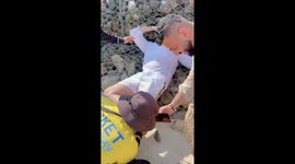 Tourist stung by sea urchin left in fits of giggles as tour guide tries to remove creature