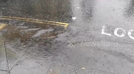 Heavy rain pours around Green Park in Central London