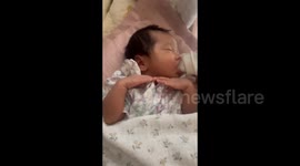 China: Adorable Baby of A Funny Pose While Drinking Milk
