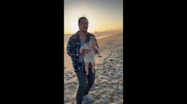 Excited Dog Ruins Baby's Beach Photo