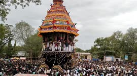 Devotees risk serious injuries to collect coconuts being launched at wall during Hindu festival