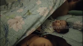 China: A Baby's woke up while the parents were sleeping
