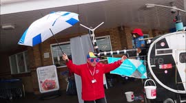 Fundraiser Tim Bell lifts spirits by 'singing in the rain' in Kent, UK
