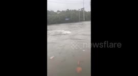 China: Resident enjoys diving in floods after downpours