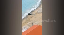 Tourists' BMW nearly swept away during drunken beach photo stunt