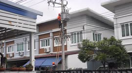 Electricity supply company employees carry out repairs and maintenance checks on electrical system on my street.