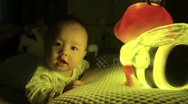 Baby's sweet smile melts hearts in warm yellow light