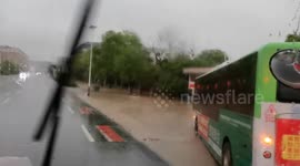 China: Firemen Braved Heavy Rain to Rescue People Trapped in Vehicles in Zhangshu