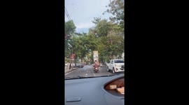 Motorcycle pillion passenger carries huge mirror
