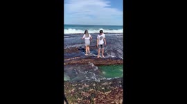 Huge wave wipes out couple posing for pictures in Australia