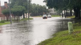 Houston storm surge fills streets in North Houston. As the latest severe weather threat rolls through the Gulf Coast region area drivers risk getting through the worst of it to get home to Preakness Apartments off Wells Fargo Drive in Houston, Texas.
