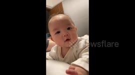 China: Baby's Adorable Efforts with Dad's Help