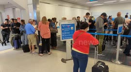 Massive airport customer service line stretches out of sight as hundreds try to rebook cancelled flights after Dallas, Texas storms