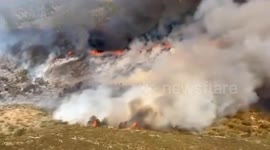 Fire crews battle blaze engulfing woodland in Spain
