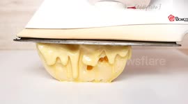 Satisfying footage shows hot iron melting cheese