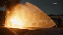 USA: Outside Fire Burns Against Structure