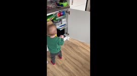 Toddler unexpectedly hit by bouncing cabinet door during playful tantrum