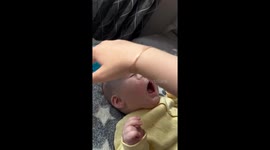 8-month-old baby soothed by ball massage