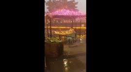 Diner ignores rain to continue eating noodles during storm