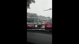 Supercar driver seen wiping windscreen by hand during rainstorm