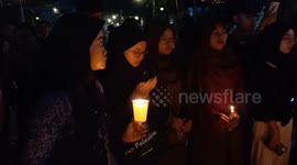 People pray and light candles as a form of solidarity and support for the Palestinian people in Bandung