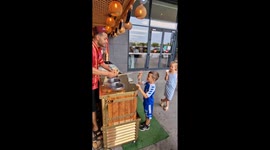 Ice Cream Vendor Plays Game With Young Customer