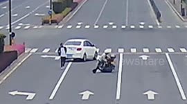 Car narrowly misses Chinese cyclists falling from motorcycle as skirt gets trapped in rear wheel