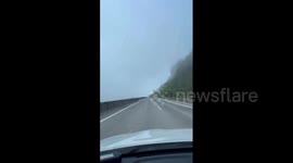 China: Vehicle Drives Through Cloud-Wrapped Highway Bridge In Guizhou